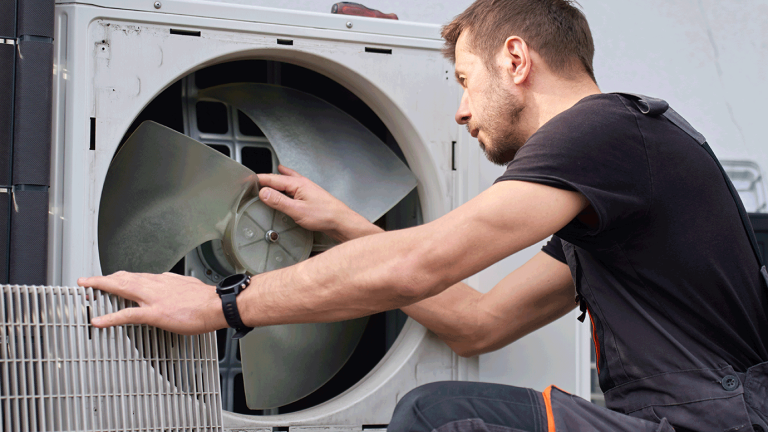 Contractor inspecting a heat pump.